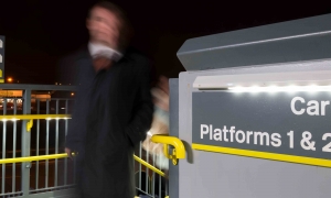 Anti-climb illuminated handrail on railway station footbridge at night time