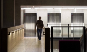 LED handrail lighting illuminates stairs inside university building